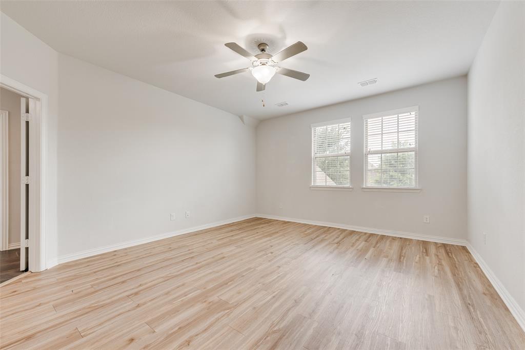628 Ansley Way Allen, TX 75013 - Photo 11 of 20 Spacious interior room featuring light wood-finish flooring, white walls, and a ceiling fan with integrated lighting