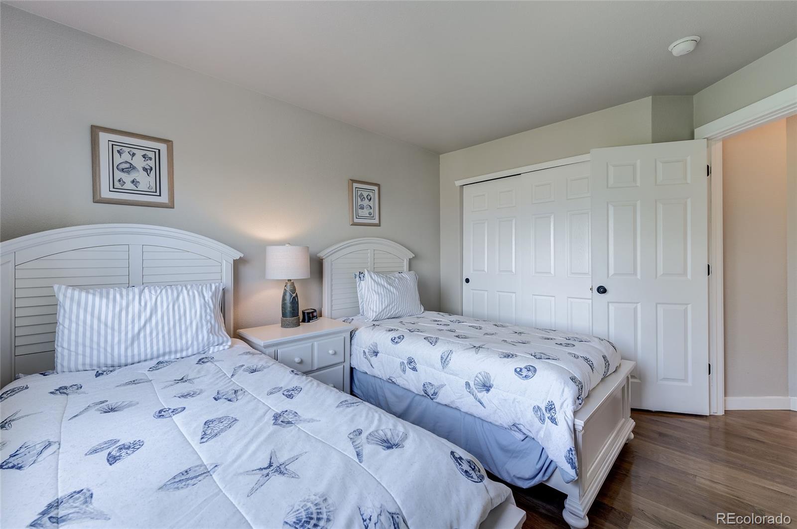 9889 Riddlewood Court Highlands Ranch, CO 80129 - Photo 32 of 38 a bedroom with two beds and a lamp