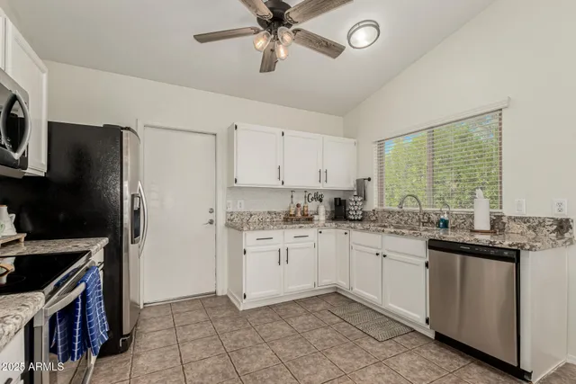 a kitchen with a sink stove and refrigerator