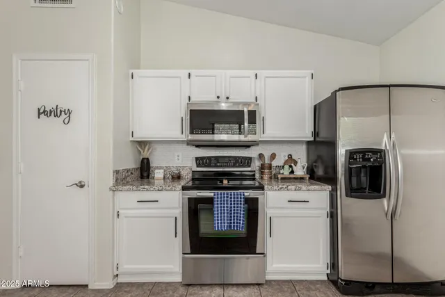 a kitchen with cabinets and stainless steel appliances
