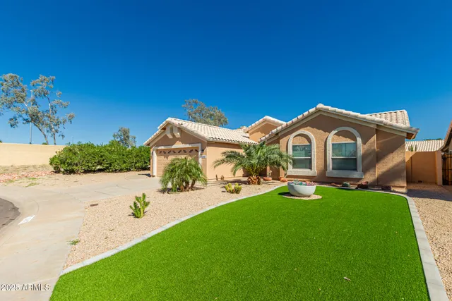 a view of an house with backyard space and sitting area