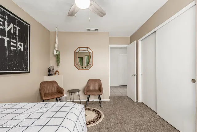 a bedroom with a bed and a chair