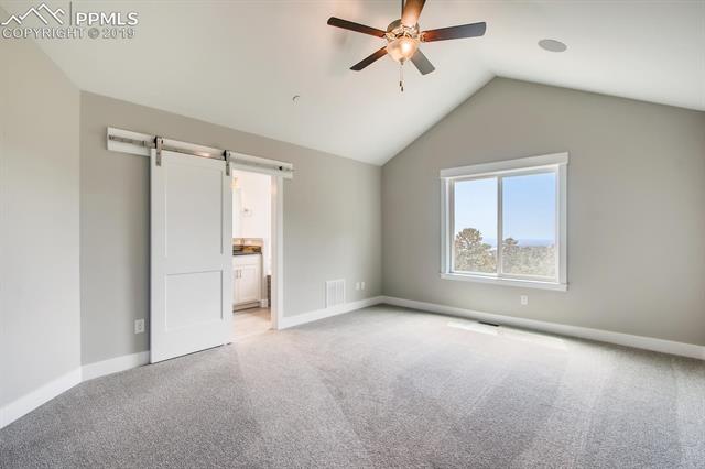 5335 Old Star Ranch View Colorado Springs, CO 80906 - Photo 7 of 13 Vaulted master bedroom with barn door