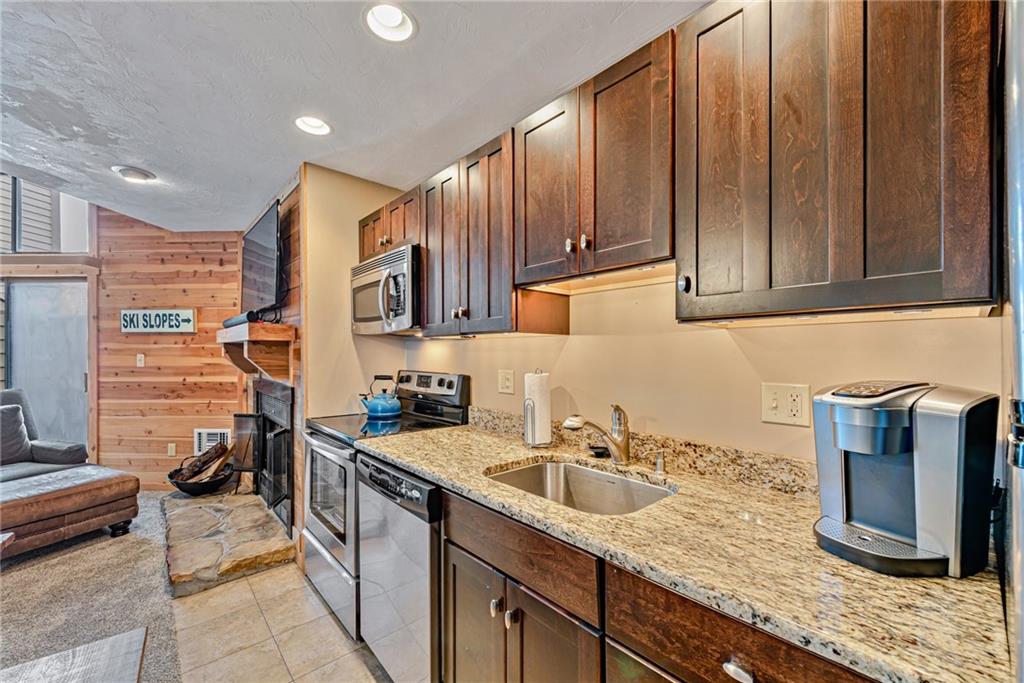 F7 Sunridge Road Champion, PA 15622 - Photo 11 of 25 a kitchen with stainless steel appliances granite countertop a sink stove and cabinets