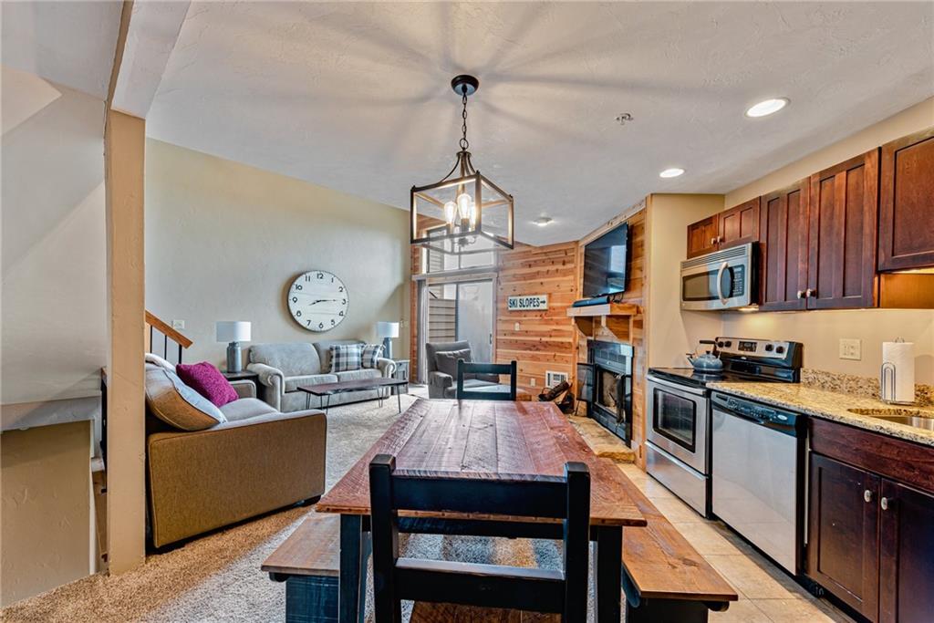 F7 Sunridge Road Champion, PA 15622 - Photo 12 of 25 a open kitchen with stainless steel appliances granite countertop a stove a refrigerator a kitchen island a dining table and chairs with wooden floor