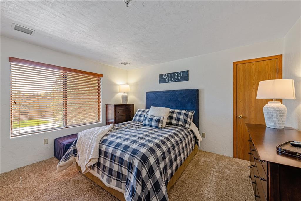 F7 Sunridge Road Champion, PA 15622 - Photo 18 of 25 a bedroom with a bed and dresser with mirror