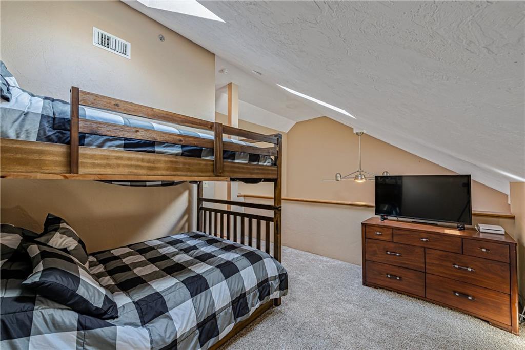 F7 Sunridge Road Champion, PA 15622 - Photo 19 of 25 a bedroom with a bed and flat screen tv