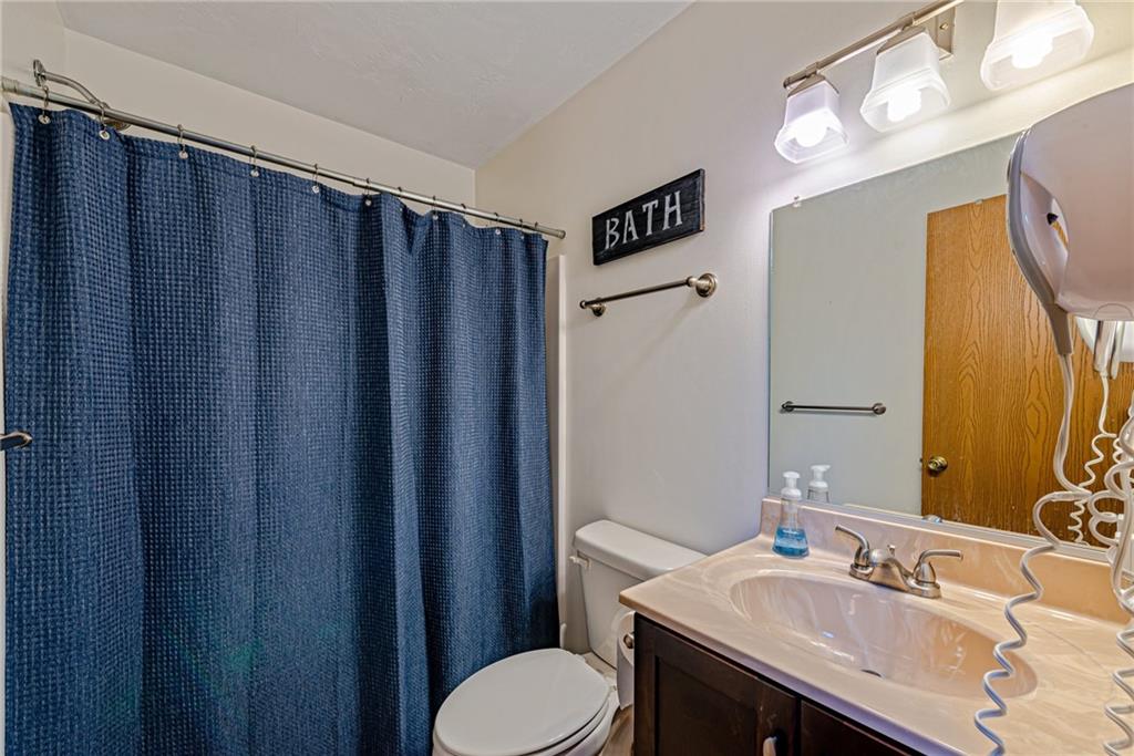 F7 Sunridge Road Champion, PA 15622 - Photo 20 of 25 a bathroom with a sink vanity mirror and toilet