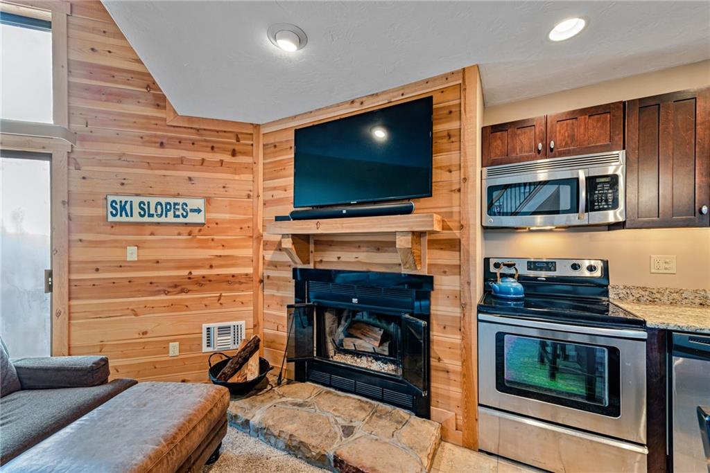F7 Sunridge Road Champion, PA 15622 - Photo 8 of 25 a living room with a fireplace and a flat screen tv