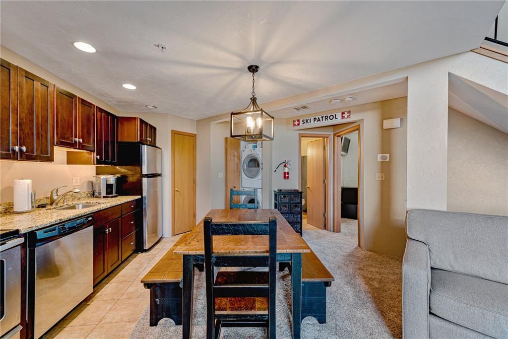 F7 Sunridge Road Champion, PA 15622 - Photo 9 of 25 a kitchen with stainless steel appliances granite countertop a refrigerator a stove and a sink with wooden floor