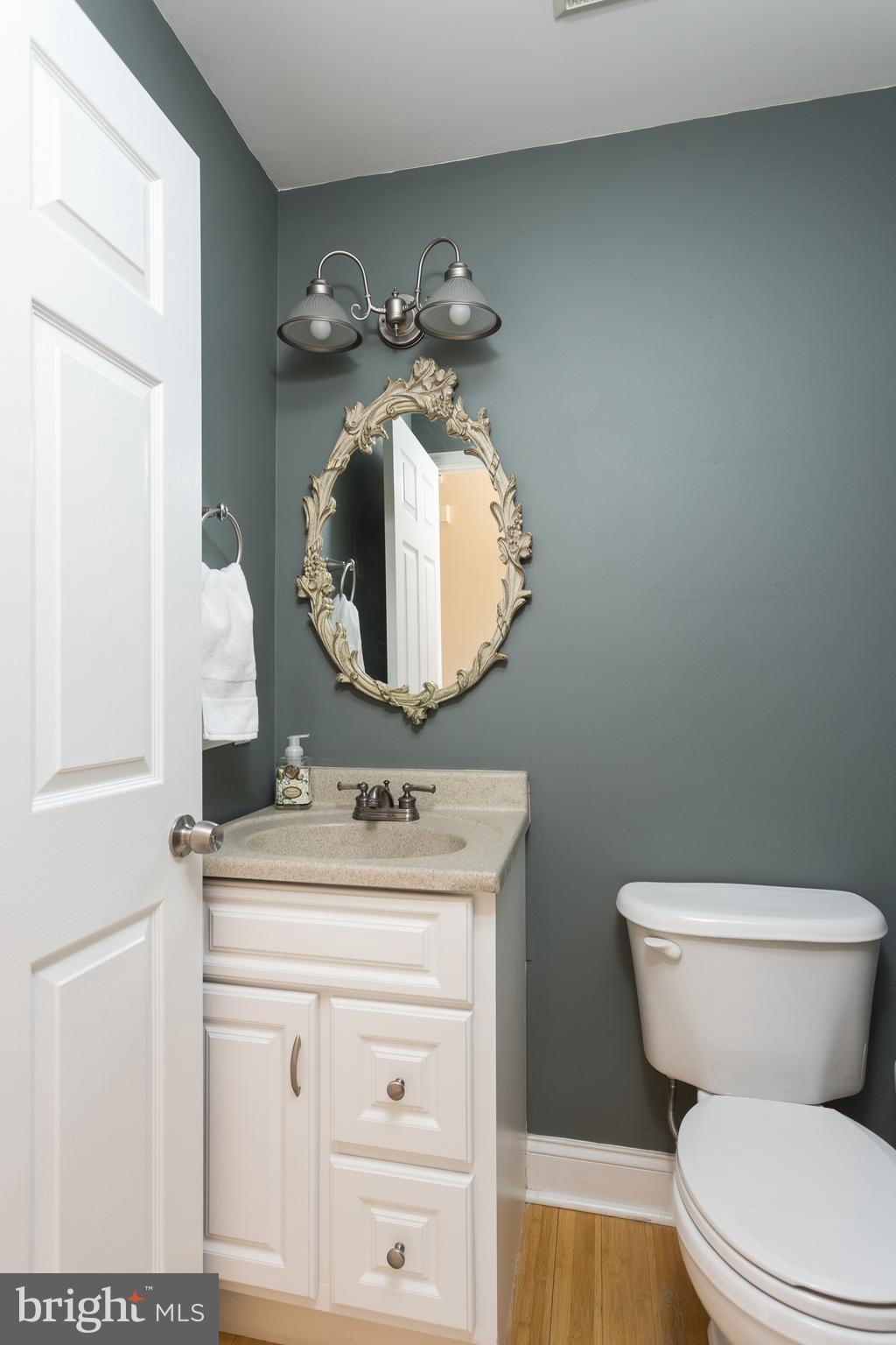 11104 Bird River Grove Road White Marsh, MD 21162 - Photo 11 of 48 a bathroom with a toilet sink and mirror
