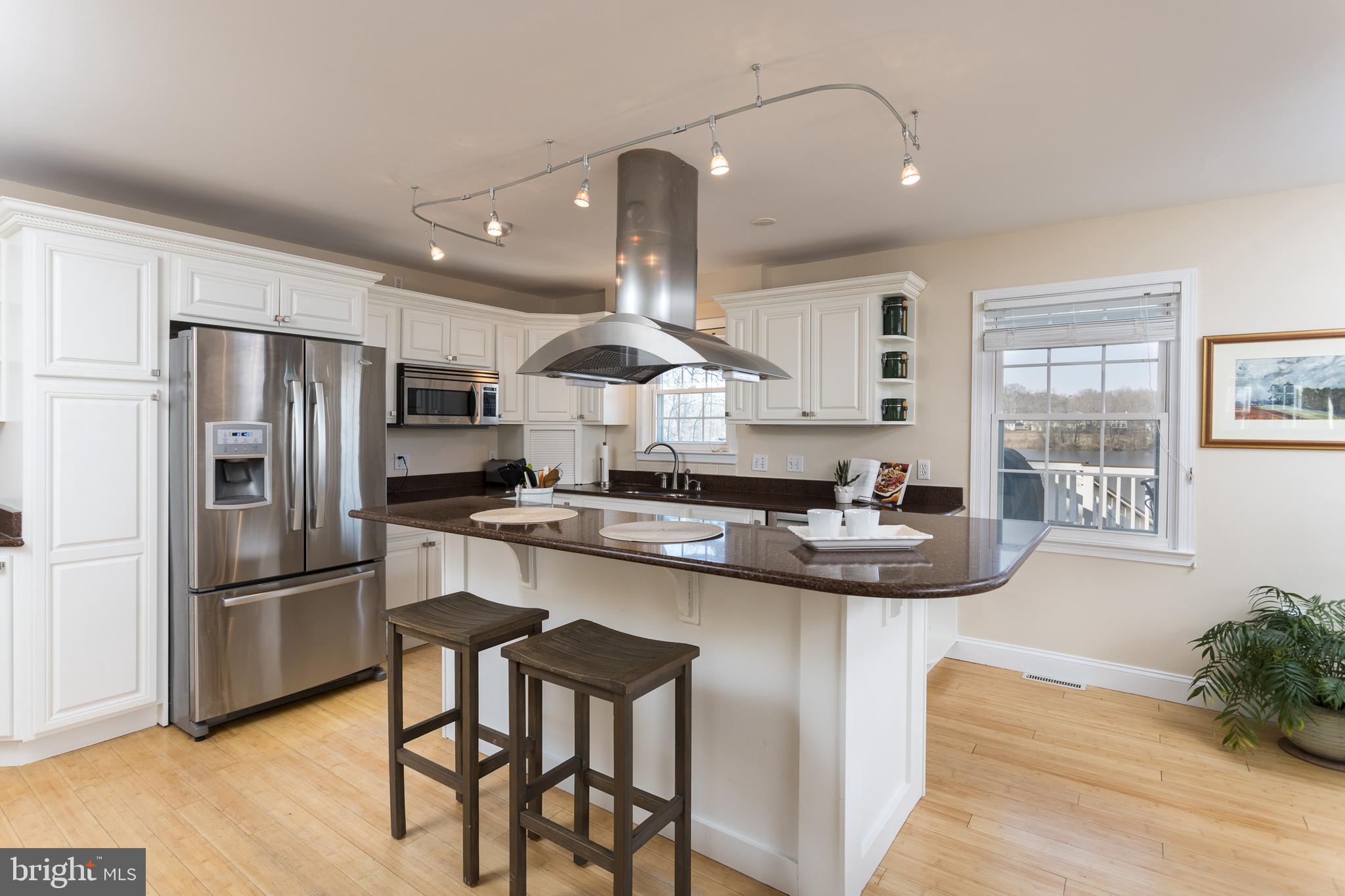11104 Bird River Grove Road White Marsh, MD 21162 - Photo 12 of 48 a kitchen with stainless steel appliances granite countertop a sink a stove a refrigerator and island with wooden floor