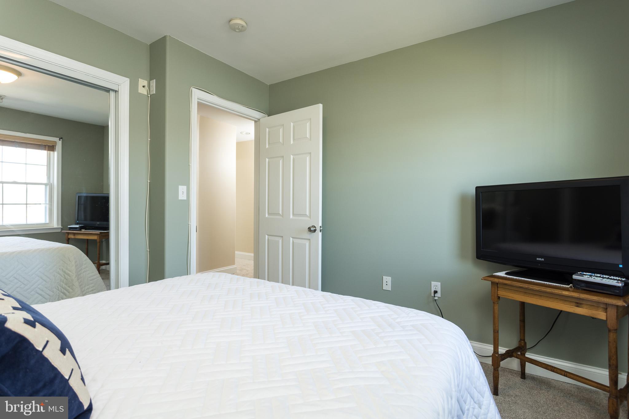 11104 Bird River Grove Road White Marsh, MD 21162 - Photo 21 of 48 a bedroom with a bed and a flat screen tv