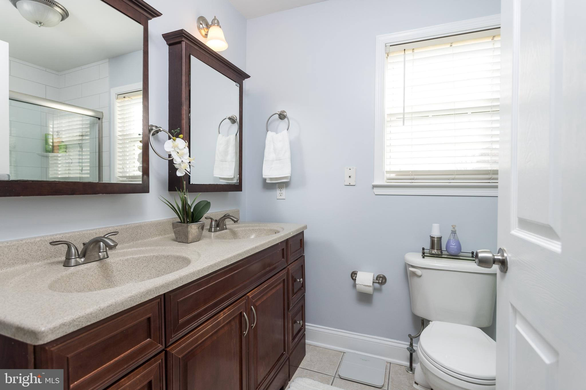 11104 Bird River Grove Road White Marsh, MD 21162 - Photo 25 of 48 a bathroom with a sink vanity mirror and toilet