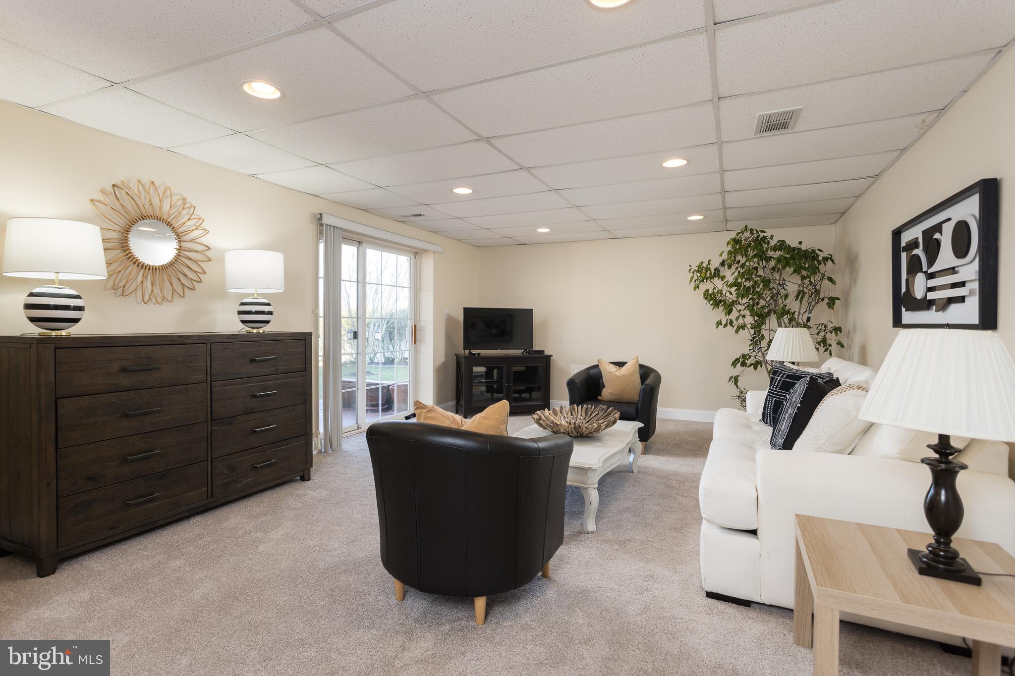 11104 Bird River Grove Road White Marsh, MD 21162 - Photo 31 of 48 a living room with furniture and a flat screen tv