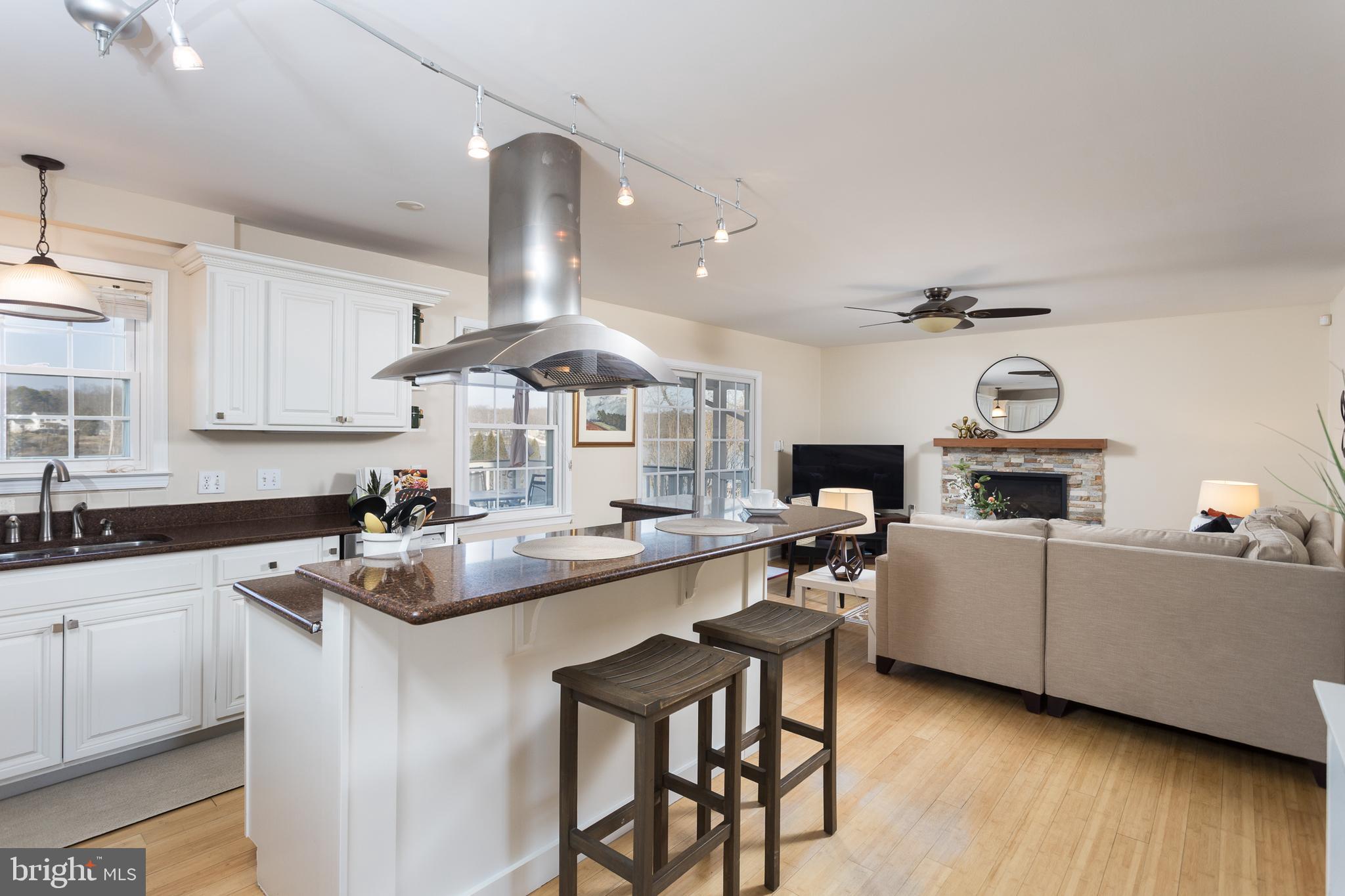 11104 Bird River Grove Road White Marsh, MD 21162 - Photo 9 of 48 a kitchen with cabinets a sink and chairs in it