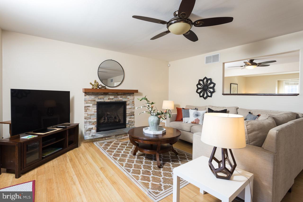 11104 Bird River Grove Road White Marsh, MD 21162 - Photo 10 of 48 a living room with furniture a rug and a fireplace