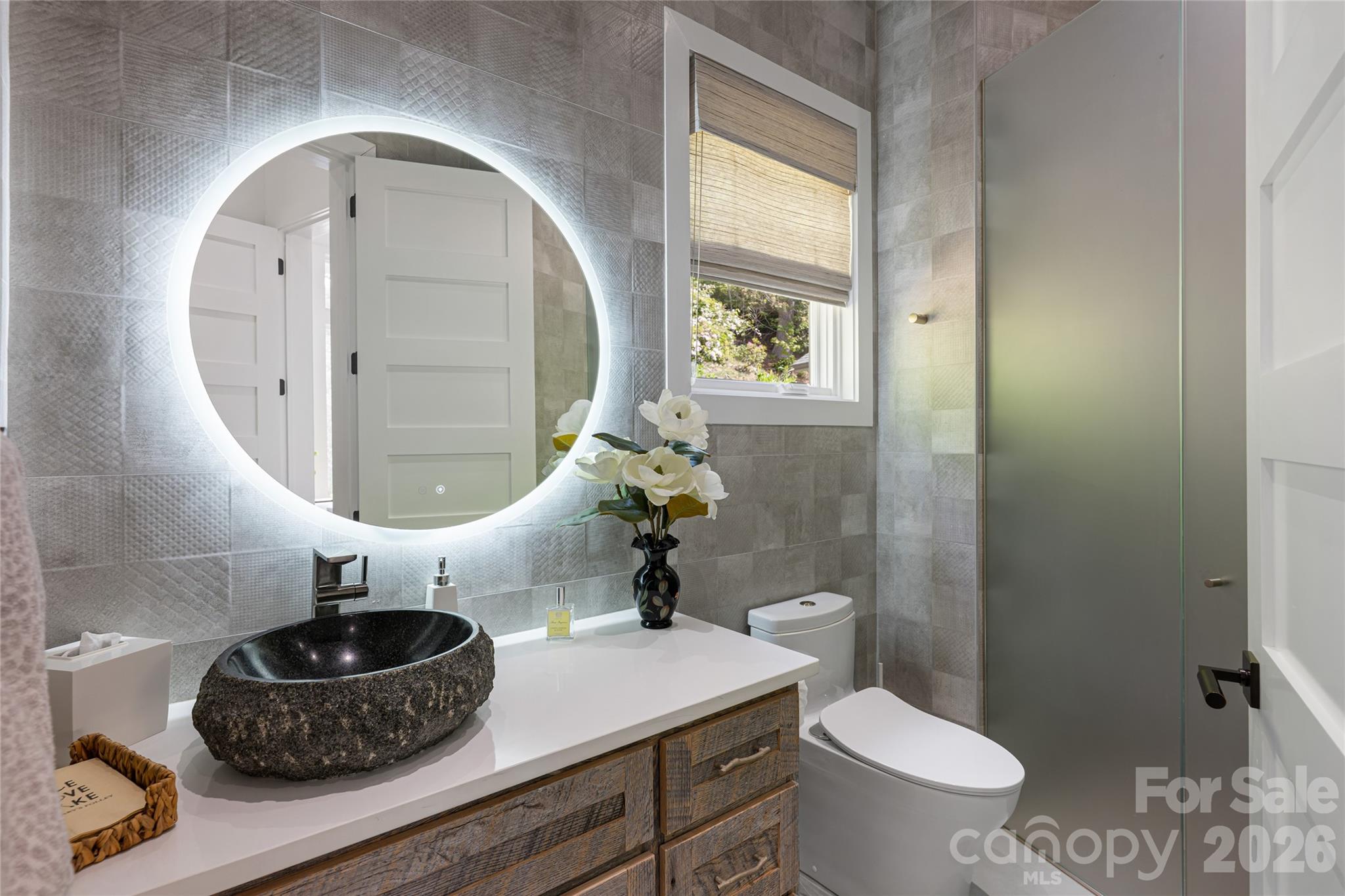 2235 Cold Mountain Road Lake Toxaway, NC 28747 - Photo 20 of 47 a bathroom with a toilet a sink and a mirror