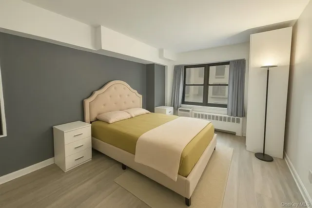 a spacious bedroom with a bed and a large window