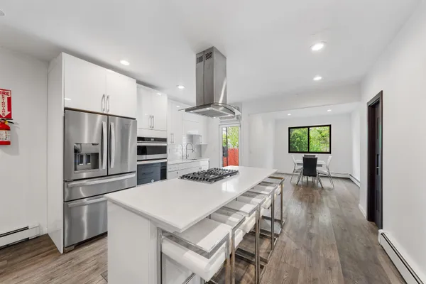 a kitchen with sink cabinets and stainless steel appliances