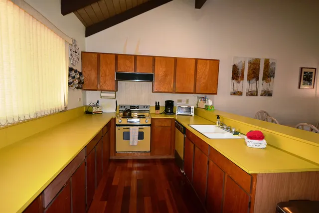 a kitchen with a sink a stove and cabinets