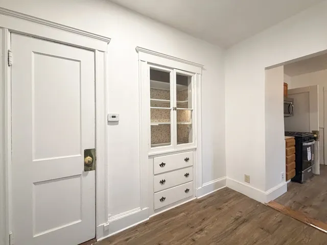 an empty room with windows and closet