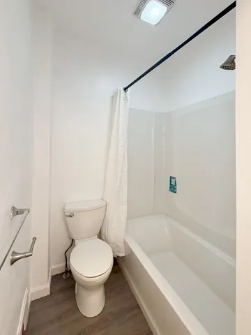 a bathroom with a toilet and a bathtub