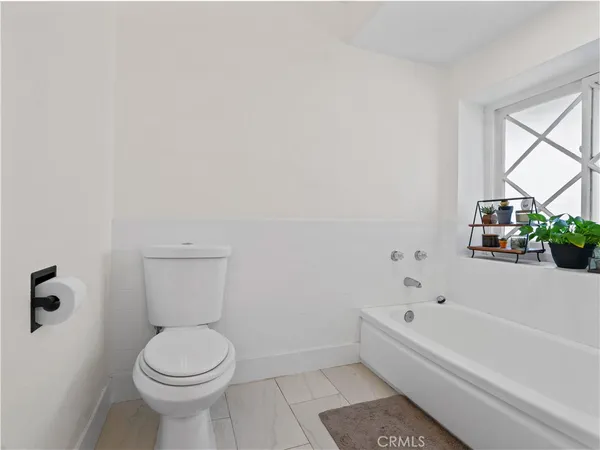 a bathroom with a bathtub and a toilet