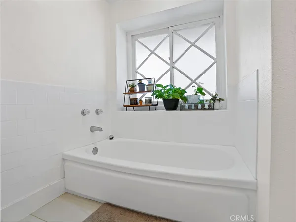 a white bath tub sitting next to a window