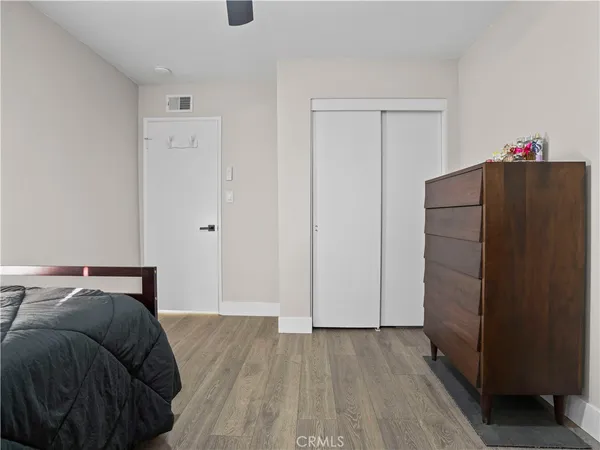 a bedroom with a bed and cabinets