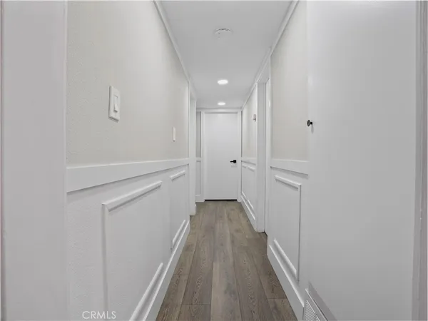 a view of a hallway with wooden floor
