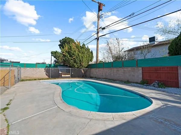 a view of a swimming pool with a patio