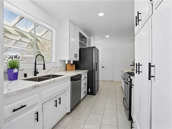 a kitchen with a sink appliances and cabinets