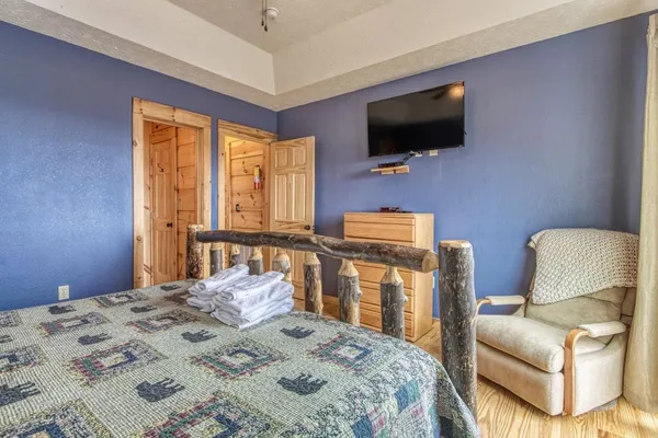 a bedroom with a bed and a chandelier