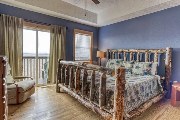 a spacious bedroom with a bed and a cabinets