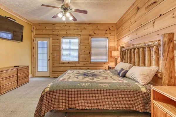 a bedroom with a bed a mirror and lamp