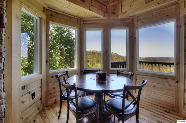 a view of a balcony with furniture and mountain view