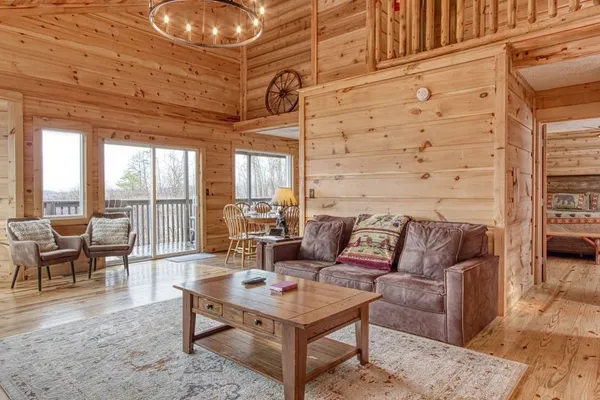 a living room with furniture and a floor to ceiling window