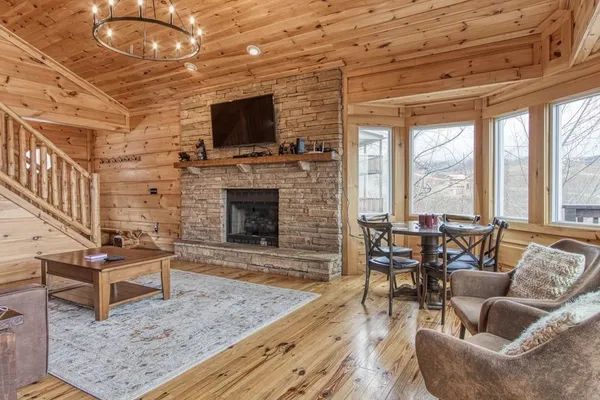 a living room with furniture a flat screen tv and a fireplace