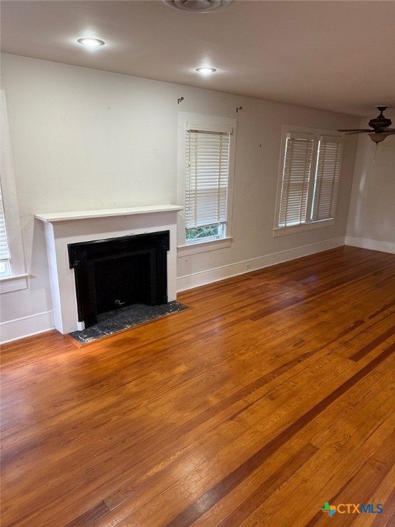 606 West Forrest Street Victoria, TX 77901 - Photo 5 of 15 an empty room with wooden floor and fireplace