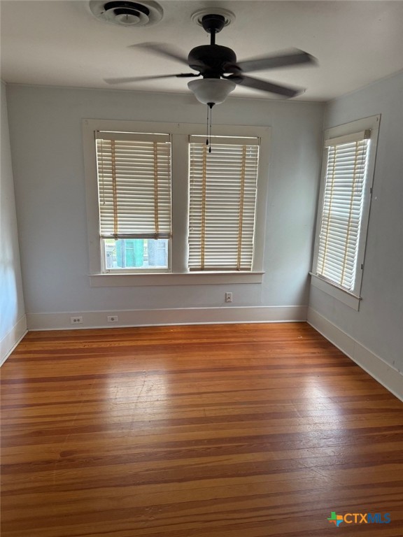 606 West Forrest Street Victoria, TX 77901 - Photo 8 of 15 a view of an empty room with wooden floor and a window