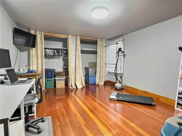 a living room with furniture gym equipment and a flat screen tv