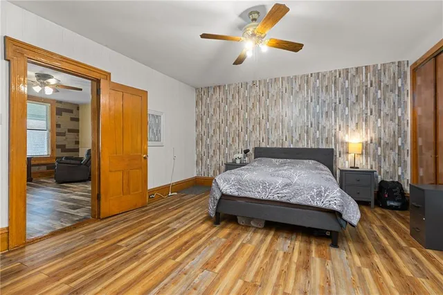 a bedroom with a bed and wooden floor