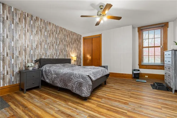 a bedroom with a bed dresser and a window
