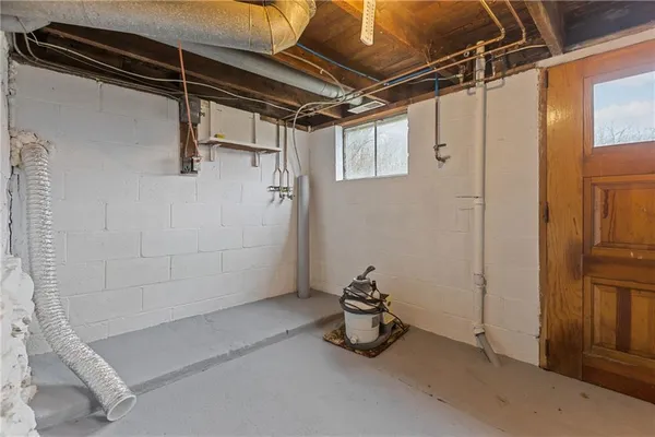 a utility room with dryer washer and other items