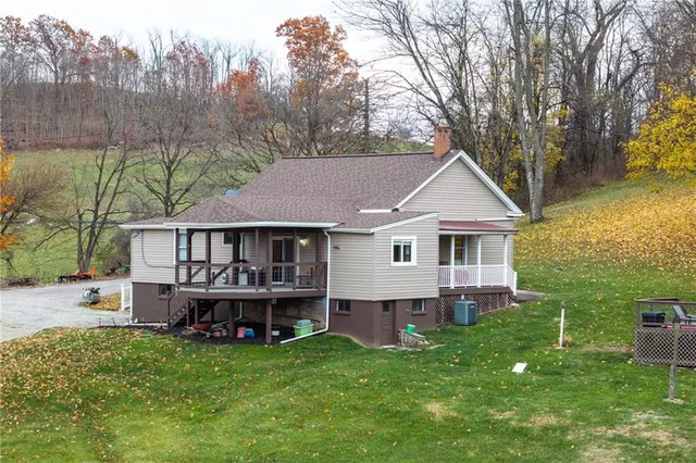 a view of a house with a yard and sitting area
