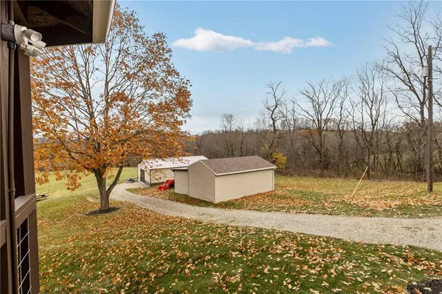 a white house that has a tree in front of it