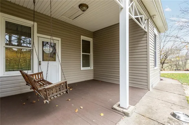 a view of a wooden bench in front of house