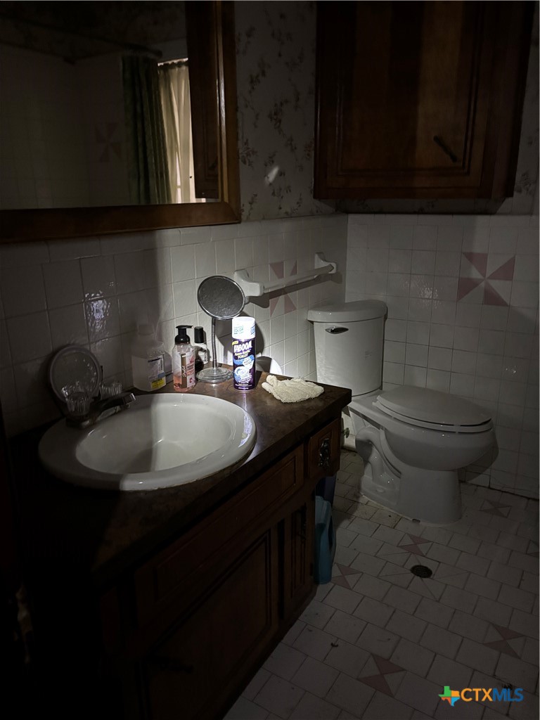350 Grand Street Placedo, TX 77977 - Photo 11 of 15 a bathroom with a sink and a toilet