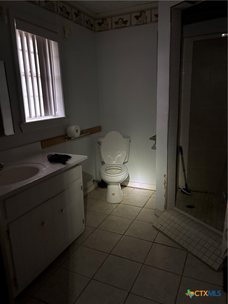 350 Grand Street Placedo, TX 77977 - Photo 15 of 15 a bathroom with a toilet sink and mirror